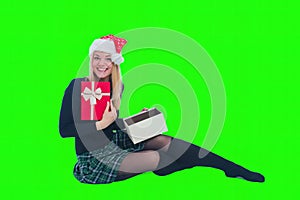 woman sitting with christmas hat and present in isolated background