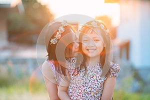 Happy smiling daughter and  her mother hugging with beautiful light flare.Mother day and family concept