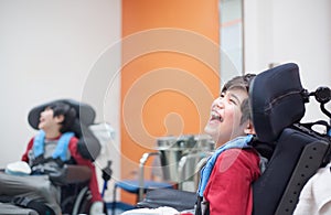 Happy, smiling disabled boy in wheelchair waiting in doctor's of