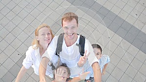 Happy smiling family does selfie. people are photographed on a cell phone