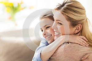 Happy smiling family hugging at home