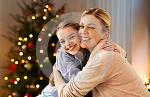 Happy smiling family hugging at home on christmas