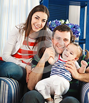 Happy smiling family with one year old baby