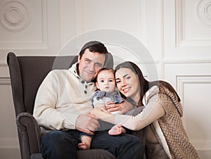 Happy smiling family with one year old baby girl