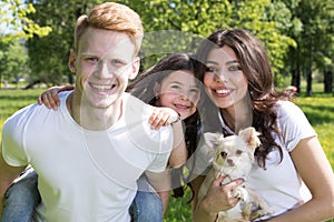 Happy smiling family with pet dog