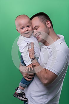 Happy smiling father embracing his baby boy