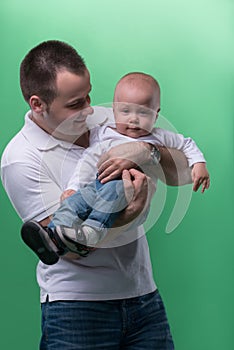 Happy smiling father embracing his baby boy