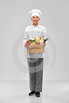 happy smiling female chef with food in wooden box