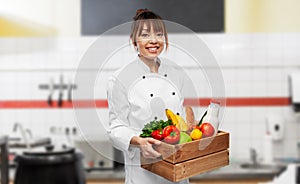 happy smiling female chef with food in wooden box