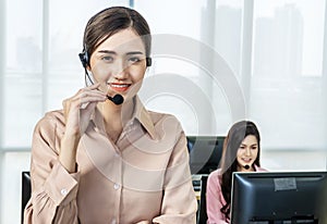 Happy smiling female customer support phone operator at workplace, Call center business woman talking on headset