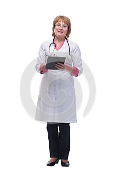 Happy smiling female doctor with stethoscope writing on clipboard