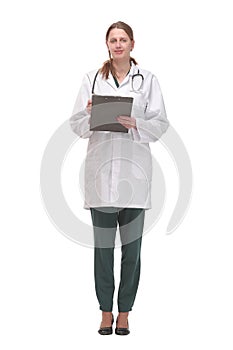 Happy smiling female doctor with stethoscope writing on clipboard