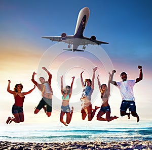 Happy smiling friends jumping on the beach with an aircraft on the sky