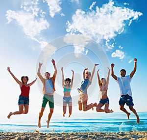 Happy smiling friends jumping over a blue sky with a world map made of clouds