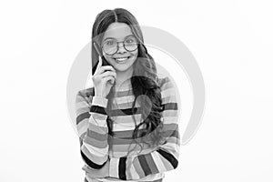 Happy smiling girl 12, 13, 14 years old with smart phone. Hipster teen girl types message on cellphone, enjoys mobile