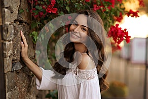 Happy smiling girl against flowers