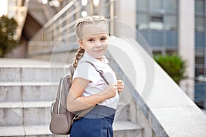 Happy smiling girl is going to school for the first time with bag go to elementary school