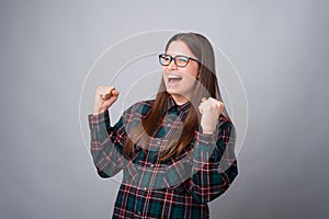 Happy smiling girl is making the winner gesture