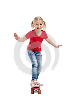 Happy smiling girl riding a skateboard