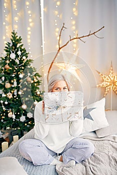 Happy smiling girl woman with christmas gift box. Christmas atmosphere