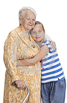 Happy smiling grandmother with granddaughter hugging in studio