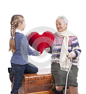 Happy smiling grandmother with granddaughter posing in studio