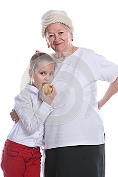 Happy smiling grandmother with granddaughter posing in studio