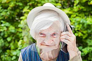 Happy smiling grandmother talking on mobile phone