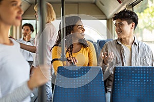 Happy smiling guy and lady taking bus and talking