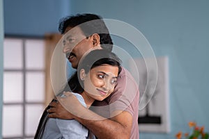 Happy smiling indian daughter meeting her father by hugging or embracing at home - concept of family reunion