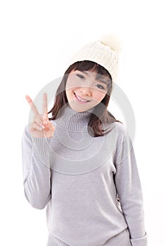 Happy, smiling, joyful woman wearing knit hat, showing 2 fingers