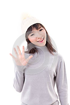 Happy, smiling, joyful woman wearing knit hat, waiving her hand to you
