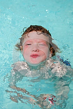 Happy smiling kid swimming