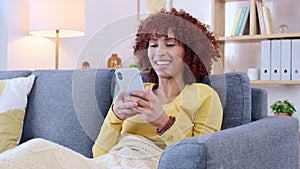 Happy, smiling and laughing woman texting, browsing and scrolling on phone at home. Cheerful female chatting on social