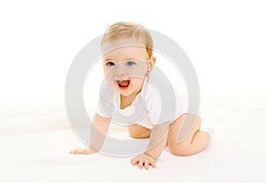 Happy smiling little baby crawls on white background