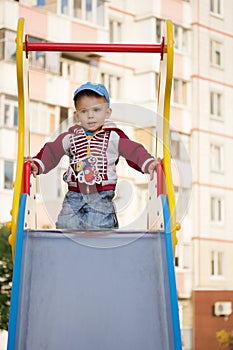 Happy smiling little boy on the playground