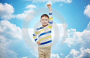 Happy smiling little boy with raised hand