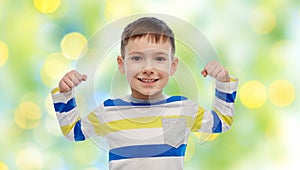 Happy smiling little boy with raised hand