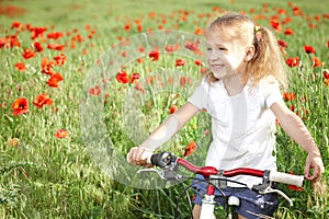 Happy smiling little girl with bicycle