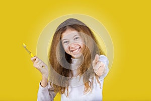 Happy, smiling little girl brushing her teeth with toothpaste.Dental health.Close-up