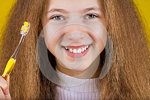 Happy, smiling little girl brushing her teeth with toothpaste.Dental health.Close-up