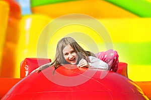 Happy Smiling Girl on Inflate Yellow Castle photo