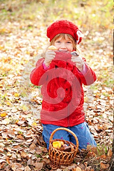 Happy smiling little girl picking mushroom