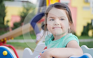 Happy smiling little girl on playground