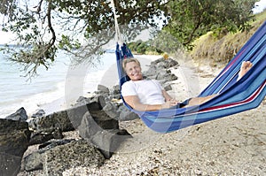 Happy smiling man in hammock