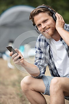 happy smiling man sitting listening to music