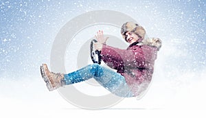 Happy smiling man in a winter clothes and hat drives a car sends greetings to the camera, in snow. Auto driver concept