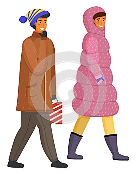 Happy smiling man and woman in warm coat walking outdoor in cold weather isolated on white