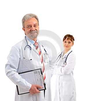 Happy smiling mature doctor writing on clipboard