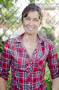 Happy smiling mature woman in red checked shirt